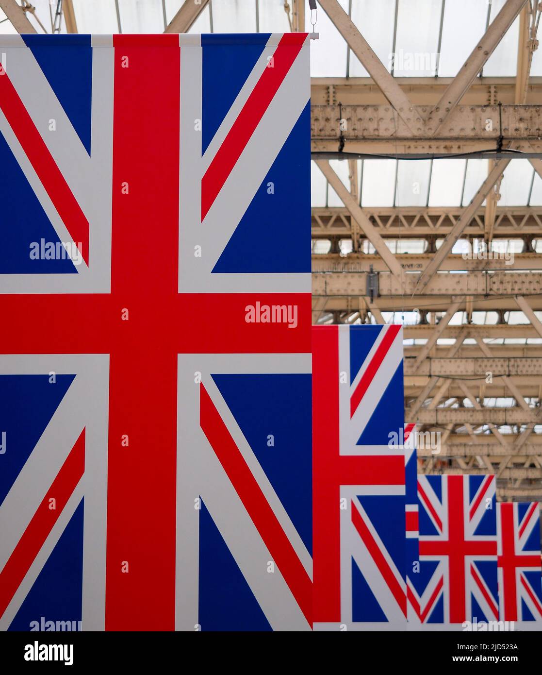 A colourful line of Union Jack flags hanging from a roof in London UK Stock Photo
