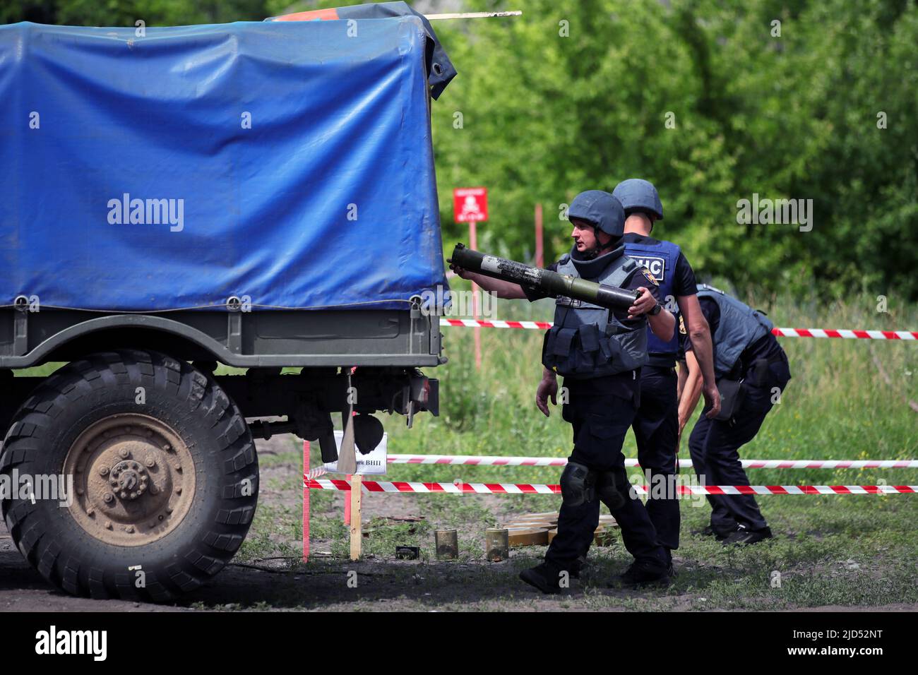 TROSTIANETS, UKRAINE - JUNE 17, 2022 - A rescuer puts an item into a truck on the premises of a brick plant where lots of ammunition and other explosi Stock Photo