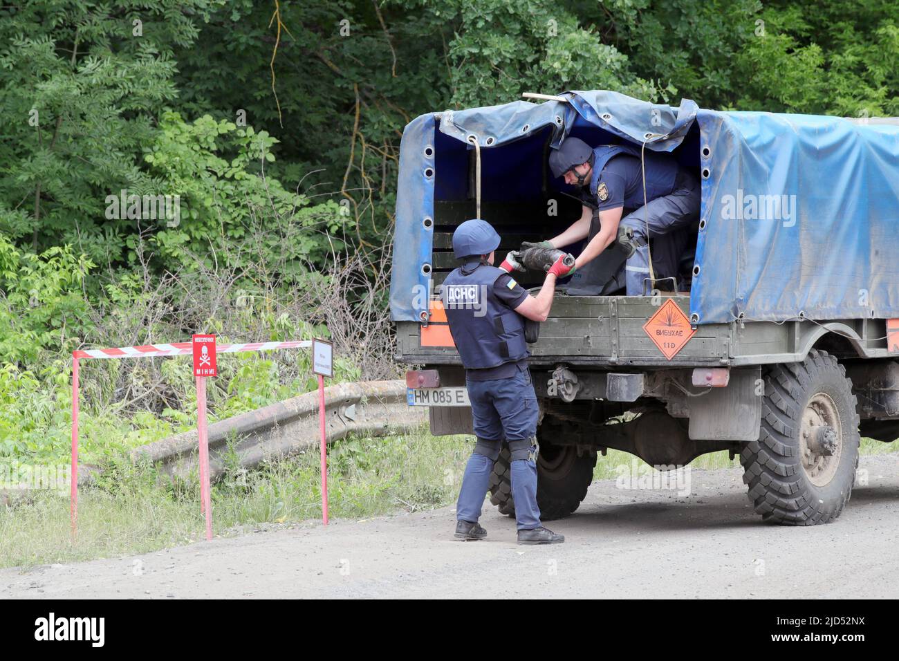 STANOVA, UKRAINE - JUNE 17, 2022 - Rescuers put ammunition lifted by State Emergency Service divers from the bottom of a body of water into the truck, Stock Photo