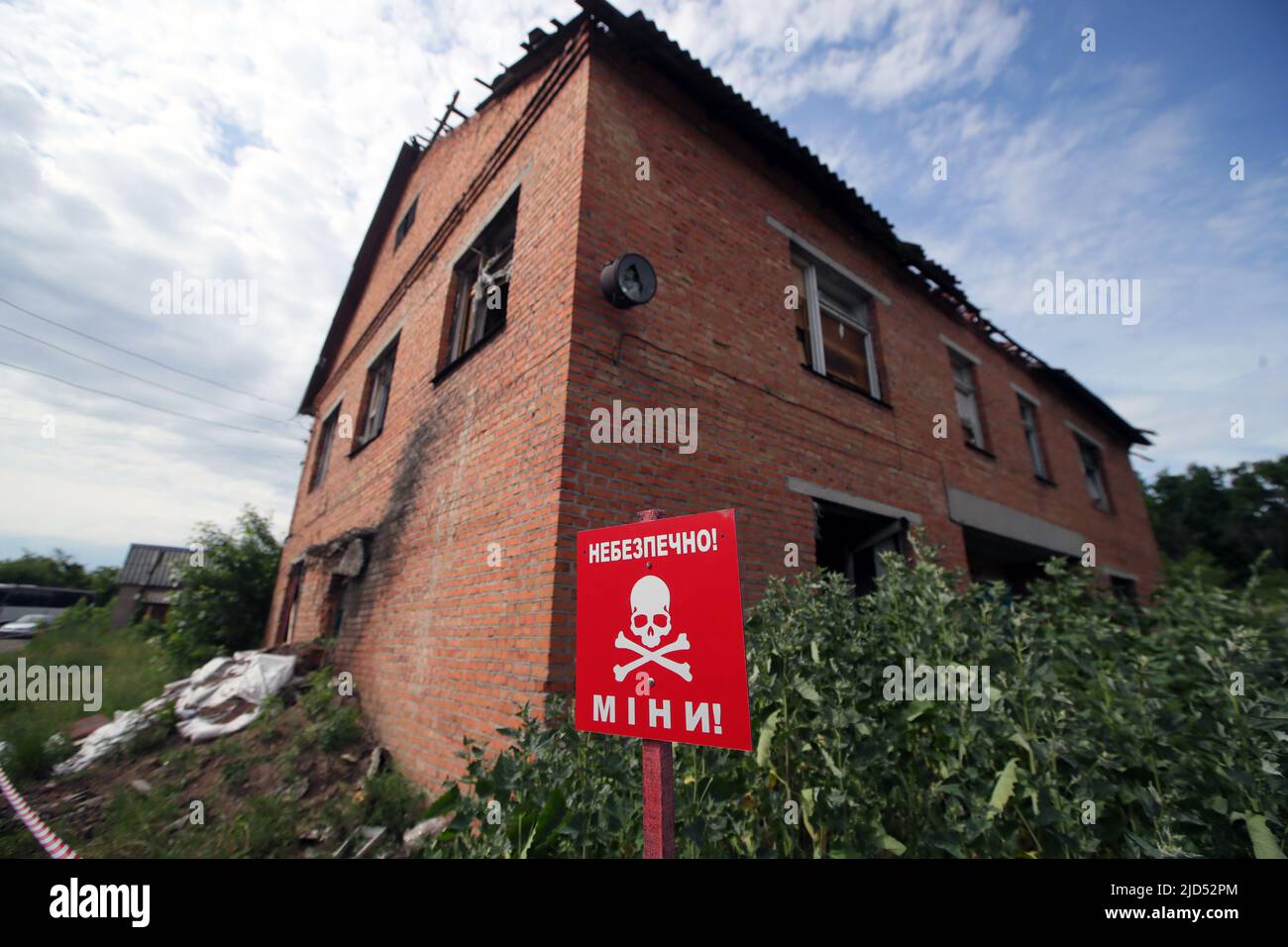 TROSTIANETS, UKRAINE - JUNE 17, 2022 - The 'Danger! Mines!' caution sign is pictured at a brick plant where lots of ammunition and other explosive ite Stock Photo