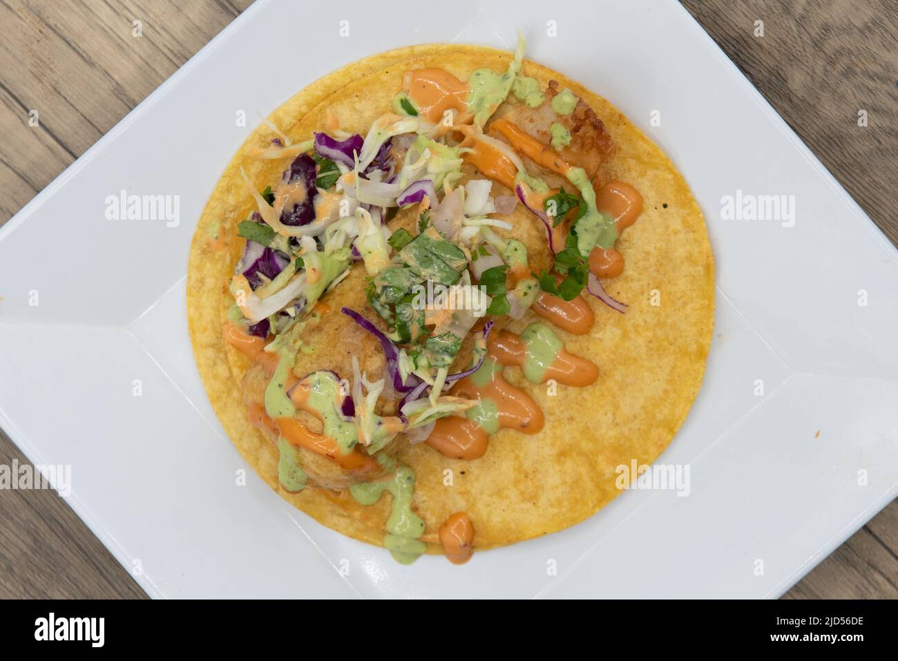 Overhead view of appetizing fish taco with perfect presentation for a tempting Mexican food delicacy. Stock Photo