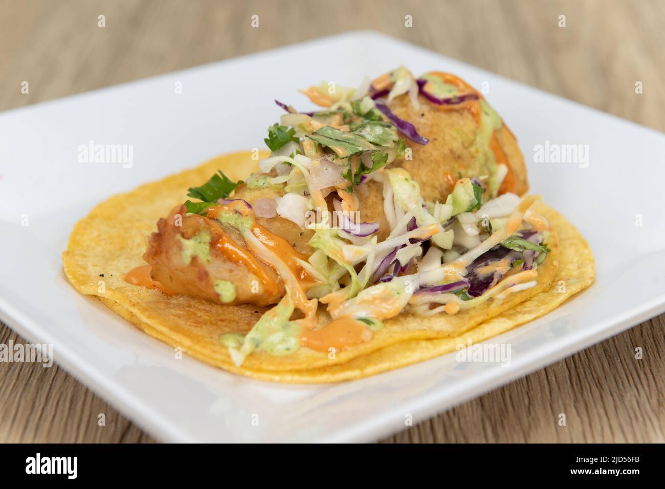 Appetizing fish taco with perfect presentation for a tempting Mexican food delicacy. Stock Photo
