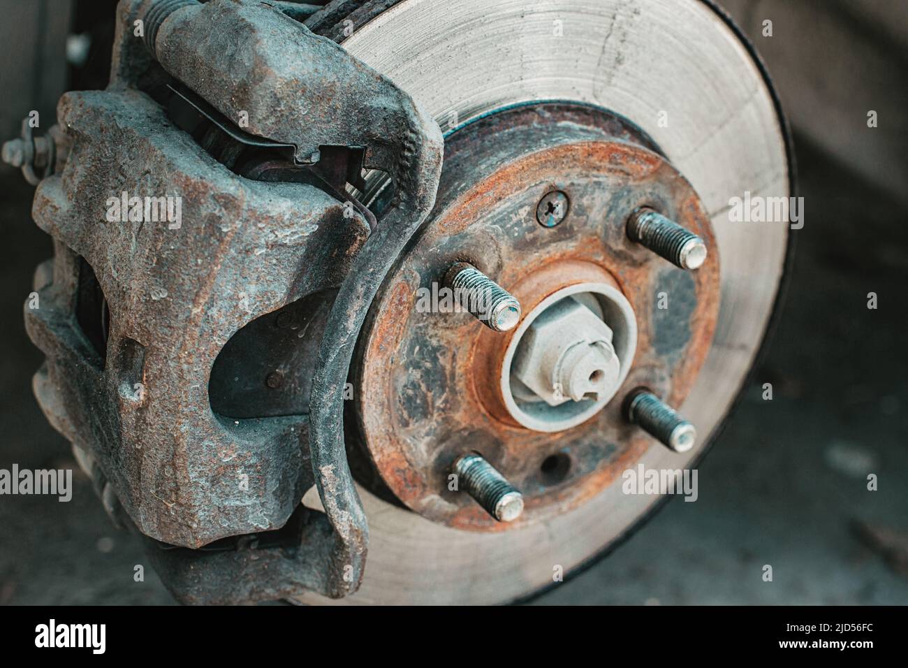 A rusty and old brake disc is serviced or replaced when the car is ...