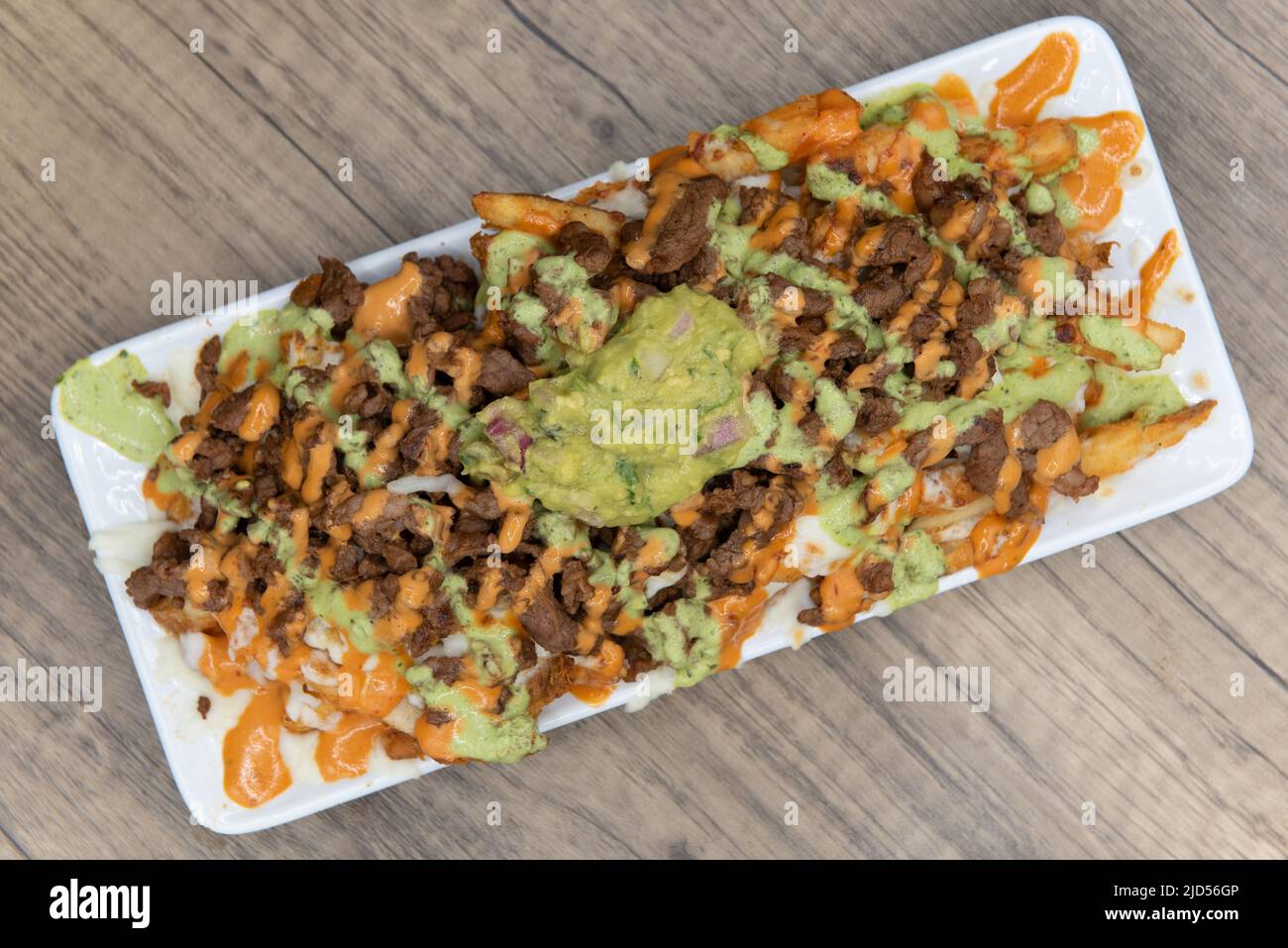 Overhead view of appetizing carne asada steak french fries for a tempting Mexican food delicacy. Stock Photo