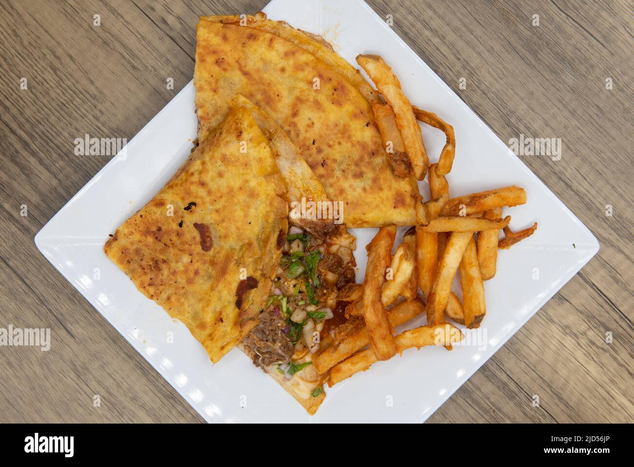 Overhead view of appetizing quesadilla birria tortilla for a tempting Mexican food delicacy. Stock Photo