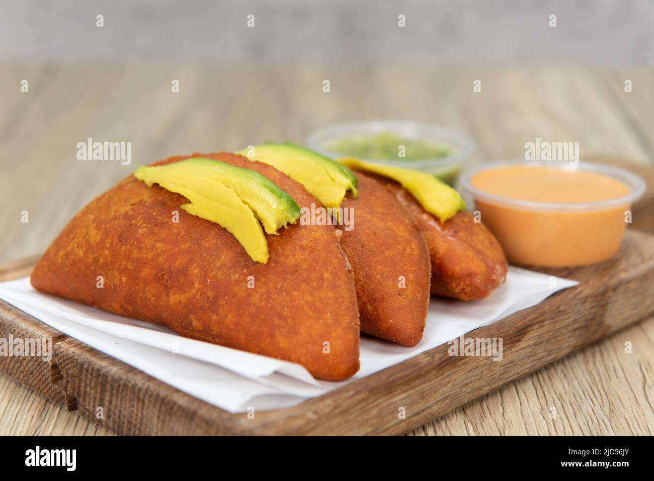 Appetizing breaded empandas on a decorative cutting board, for a tempting Mexican food delicacy. Stock Photo