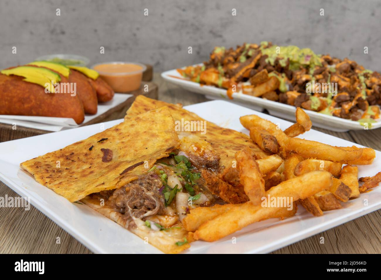Appetizing choices of quesadilla, taco, or asada fries for a tempting Mexican food delicacy. Stock Photo