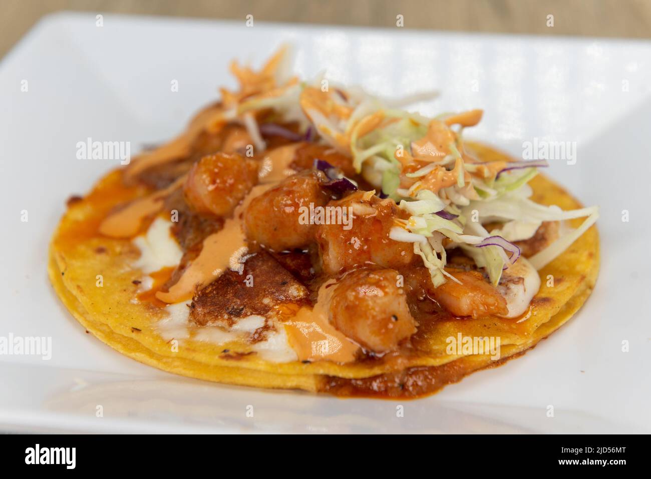 Appetizing shrimp taco with all the great toppings for a tempting Mexican food delicacy. Stock Photo