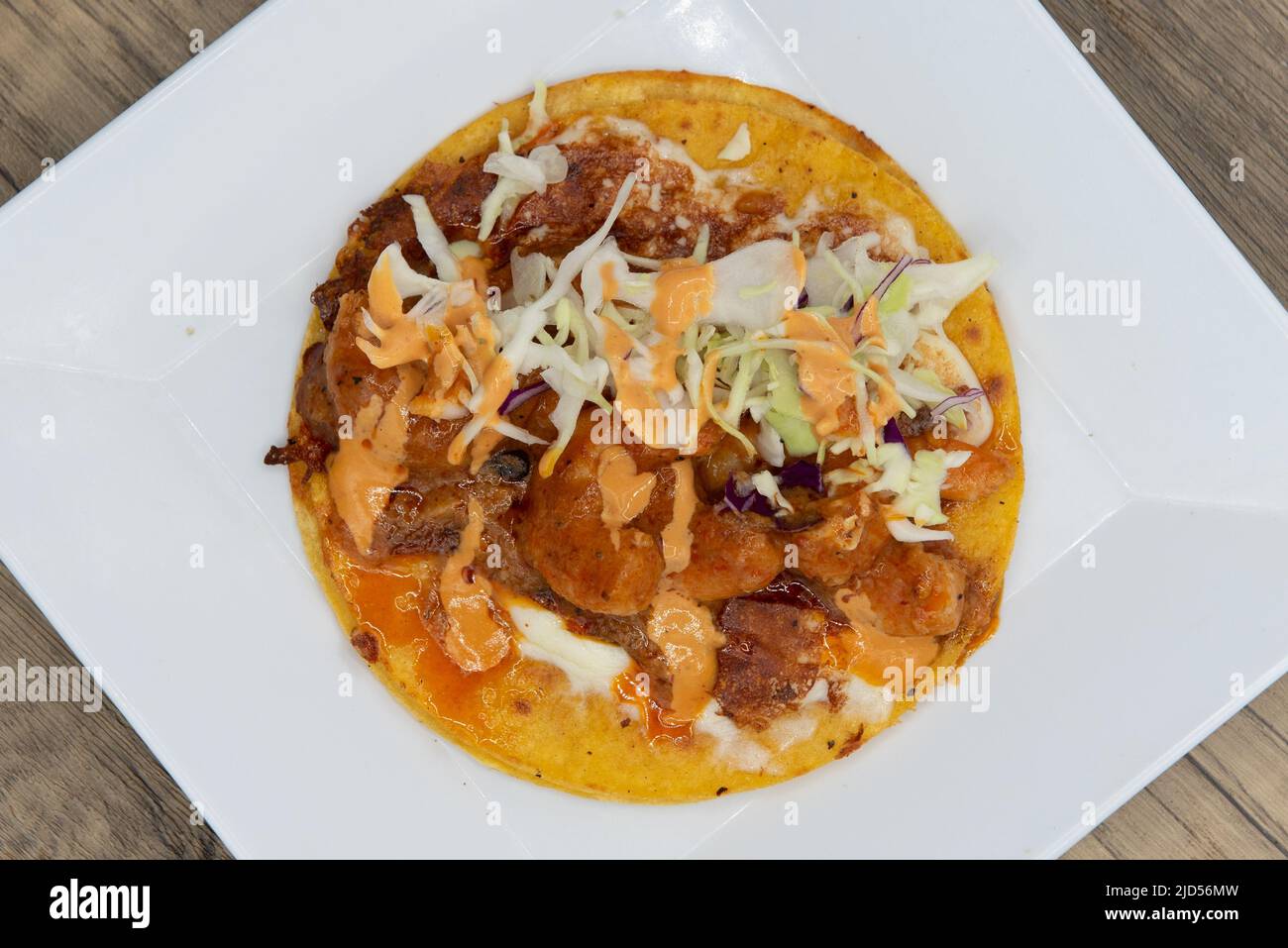 Overhead view of appetizing shrimp taco with all the great toppings for a tempting Mexican food delicacy. Stock Photo