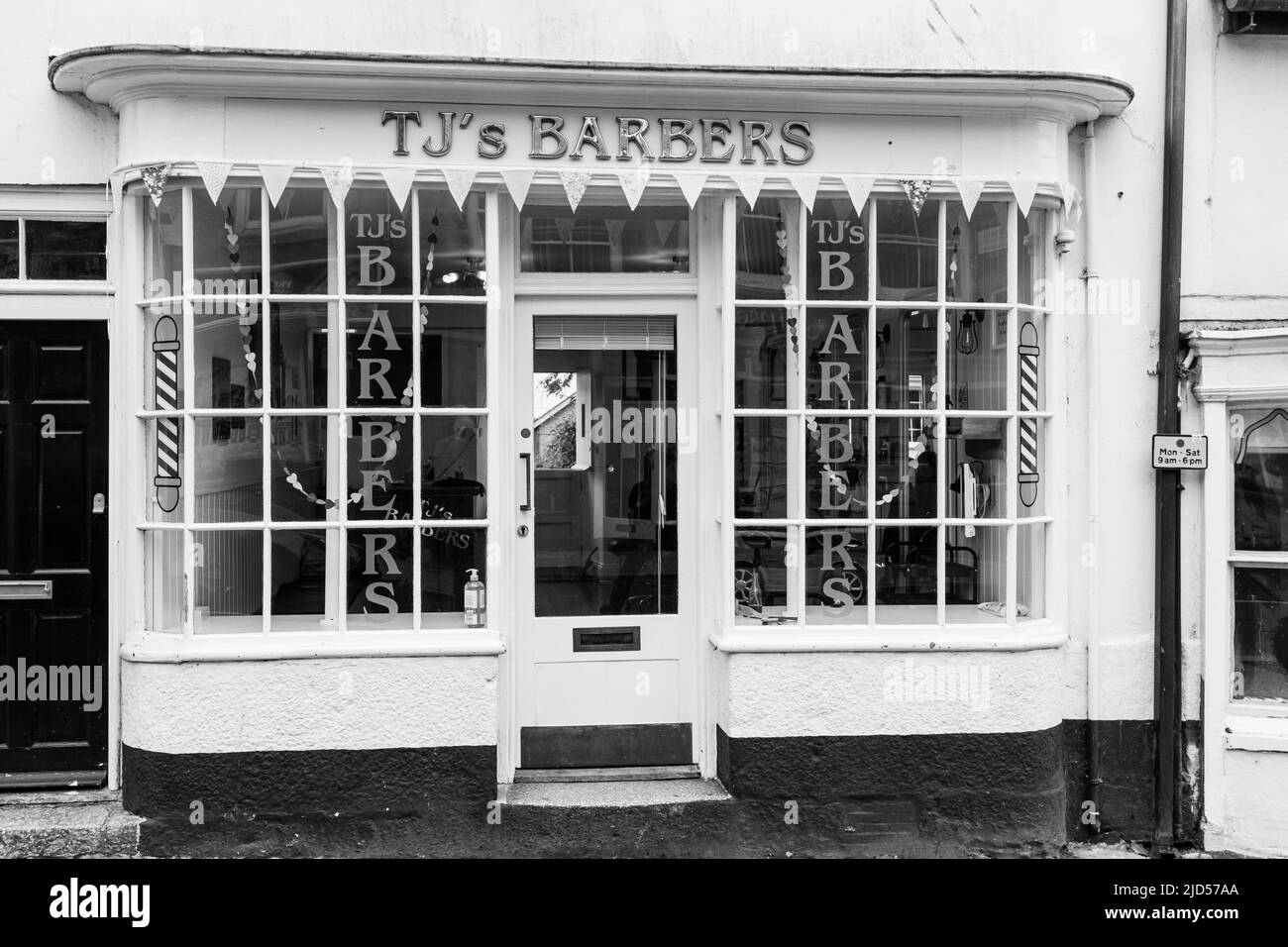 Retail outlets (TJ's Barbers) in Meneage Street, Helston, Cornwall, England Stock Photo