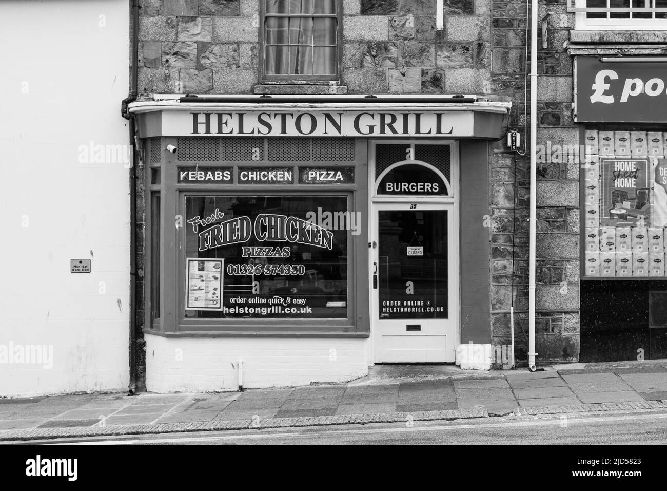 Retail outlets (Helston Grill) in Coinagehall Street, Helston, Cornwall, England Stock Photo