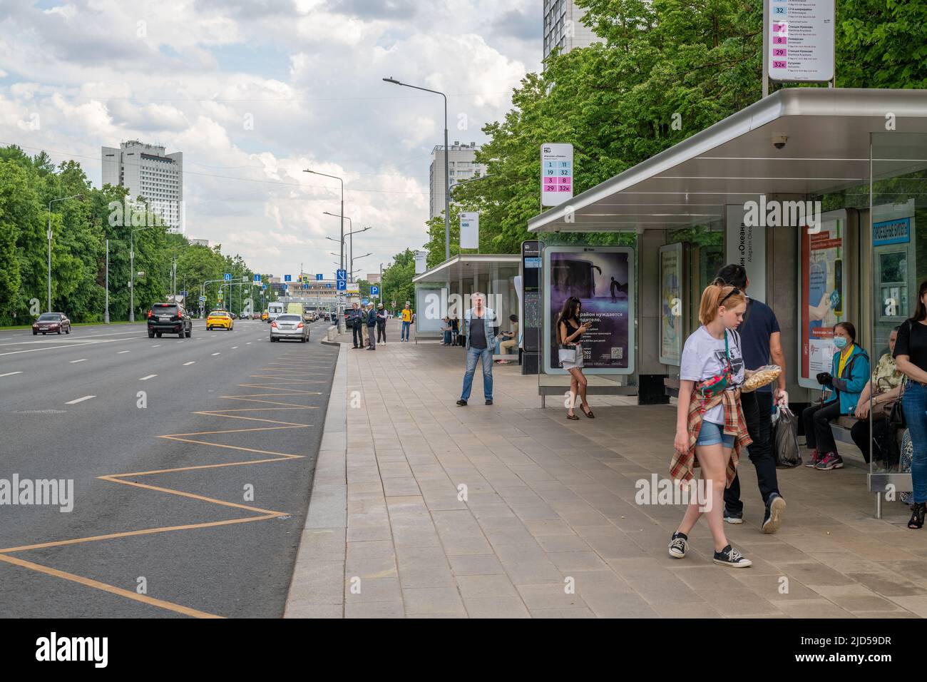 Moscow, Russia - June 14. 2022. People at bus stop on Central Avenue in Zelenograd Stock Photo