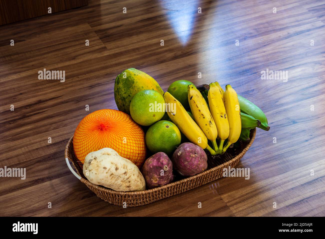 Fruits in a wooden basket on the wooden floor. Salvador, Bahia, Brazil. Stock Photo