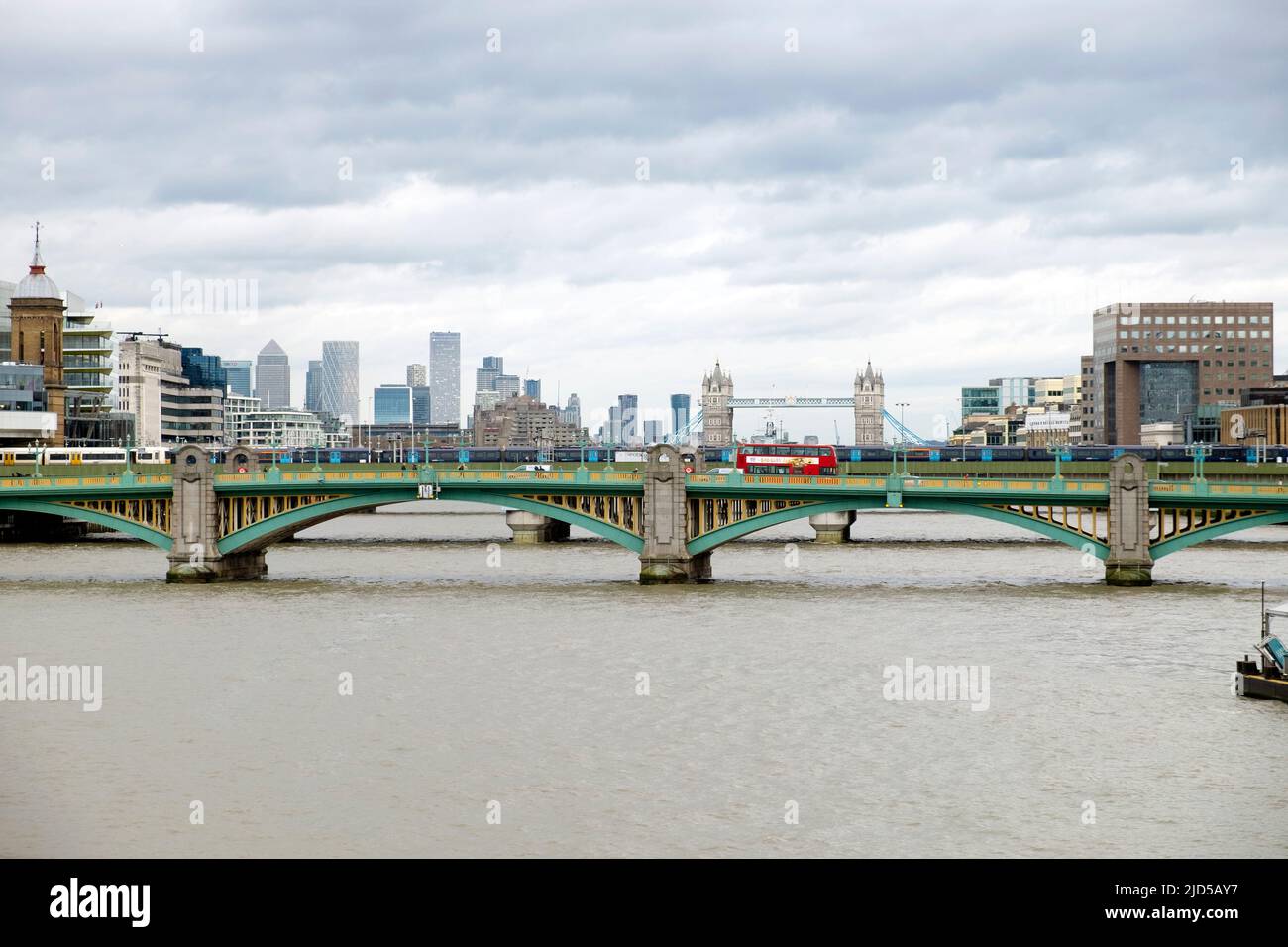 Red London double-decker bus crossing Southwark Bridge and view of River Thames looking towards Tower Bridge City of London UK in 2022 KATHY DEWITT Stock Photo