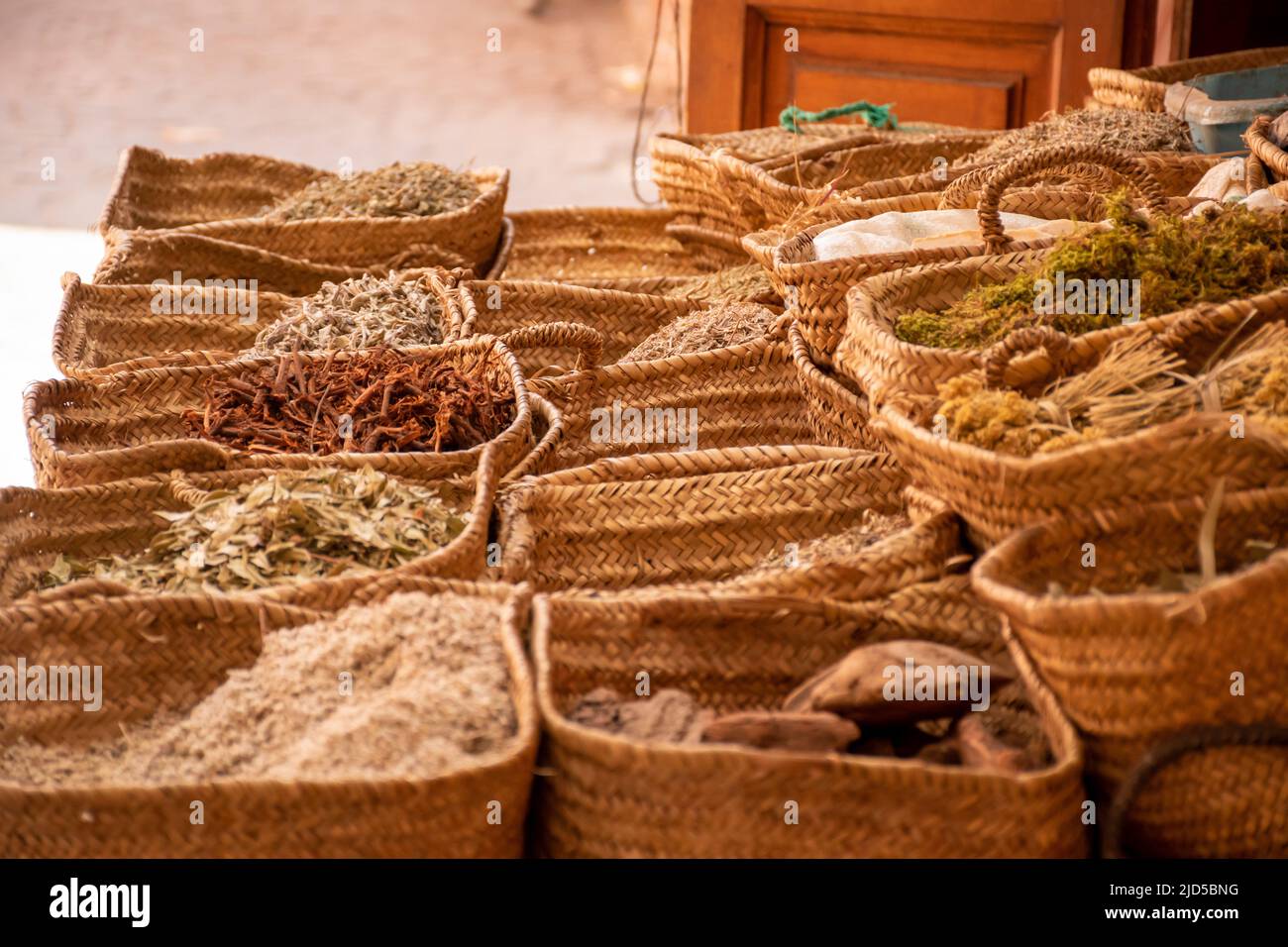 Spices and herbs in woven baskets at a street market stall in Marrakesh