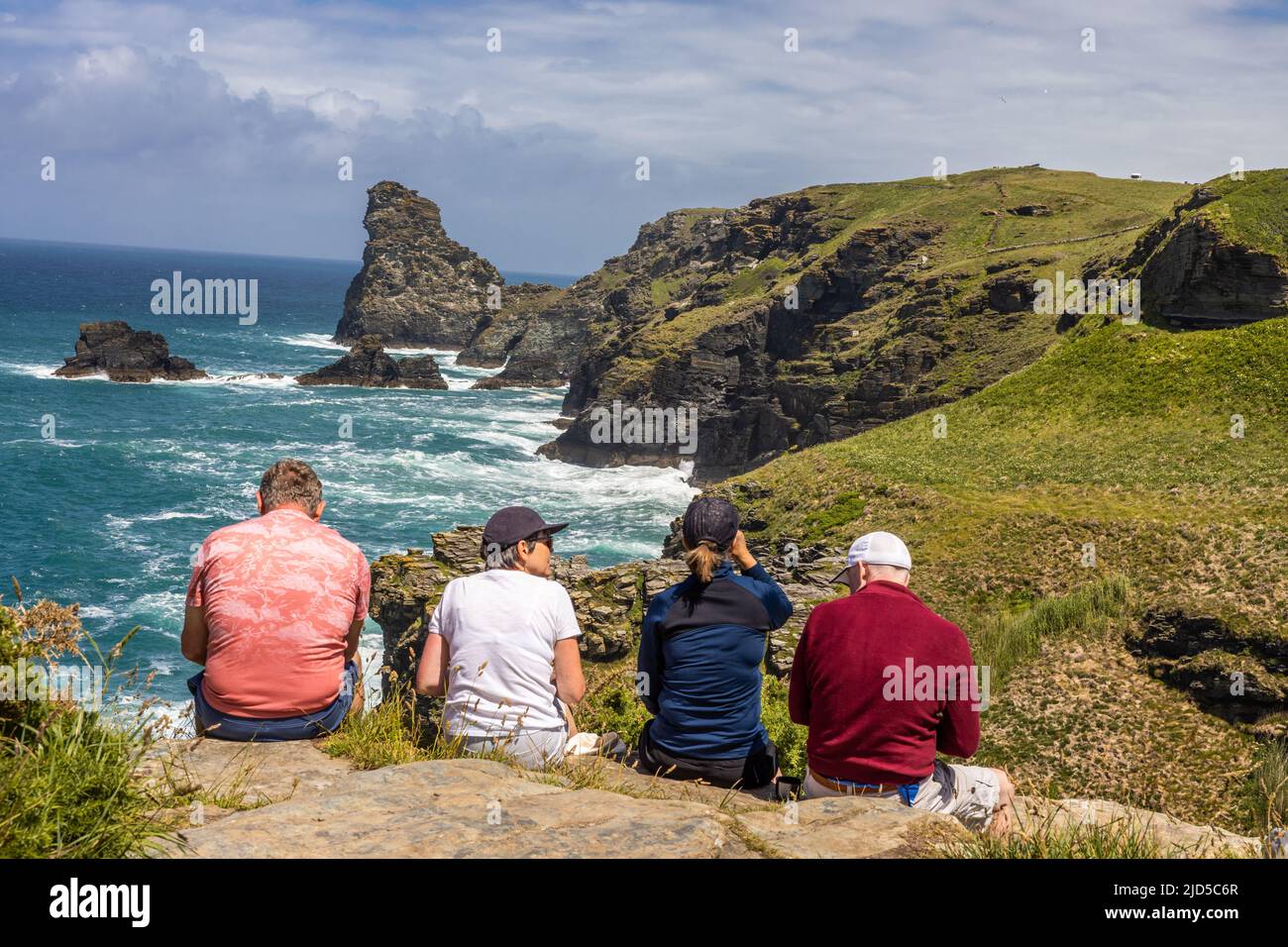 Two couples enjoying a hiking rest stop and the magnificent sea view from the southwest coast path close to Trewethett Farm Tintagel Cornwall England Stock Photo