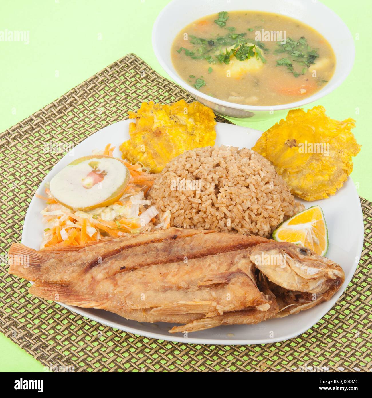 Fried fish tilapia with coconut rice and fried plantains, salad and soup Stock Photo Alamy