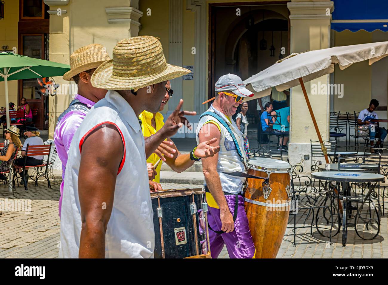 Street musicians strolling over Plaza Vieja in Havana, Cuba Stock Photo