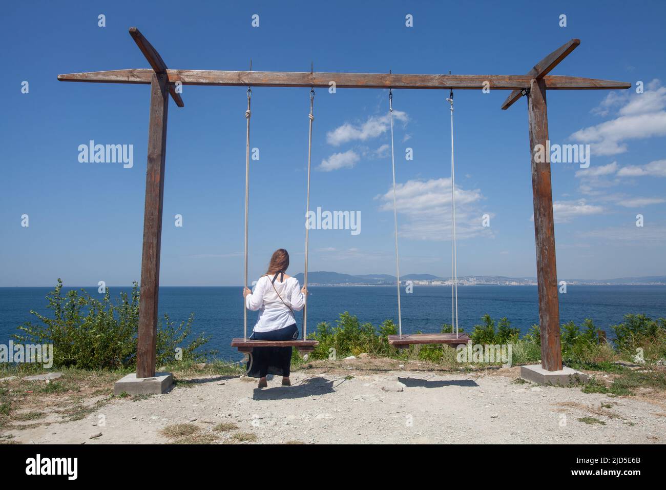 Woman on a swing on summer day Stock Photo