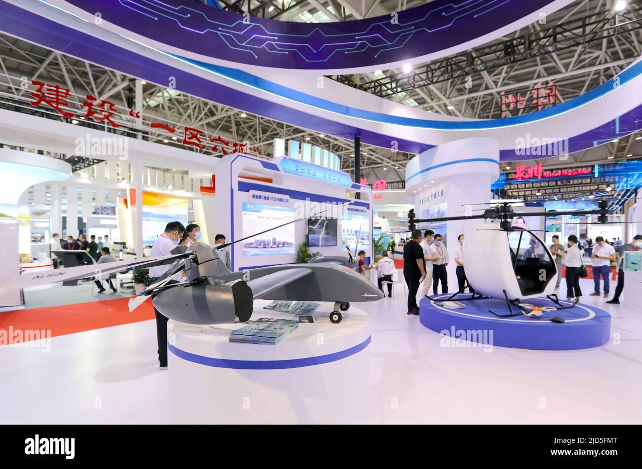 FUZHOU, CHINA - JUNE 18, 2022 - New manned aircraft and unmanned aerial vehicles (UAVs) are seen at the Exhibition area at The Straits Convention and Stock Photo