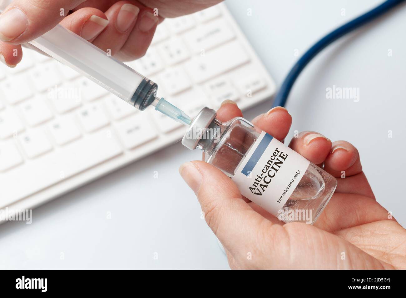 Female doctor fills a syringe with cancer vaccine Stock Photo