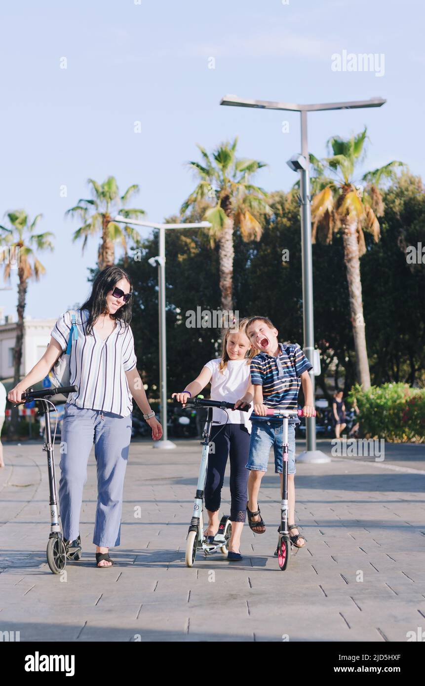 Happy smiling and screaming male tourist in helmet and sunglasses riding motorbike  scooter during his tropical vacation under palm trees Stock Photo - Alamy