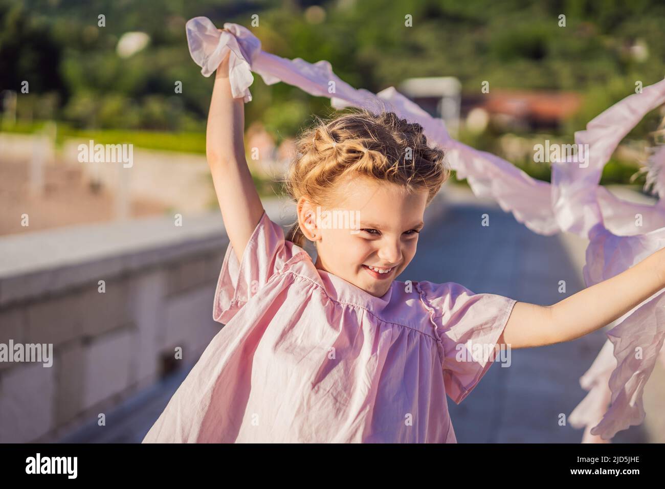 Emotional little girl in a pink dress Stock Photo - Alamy