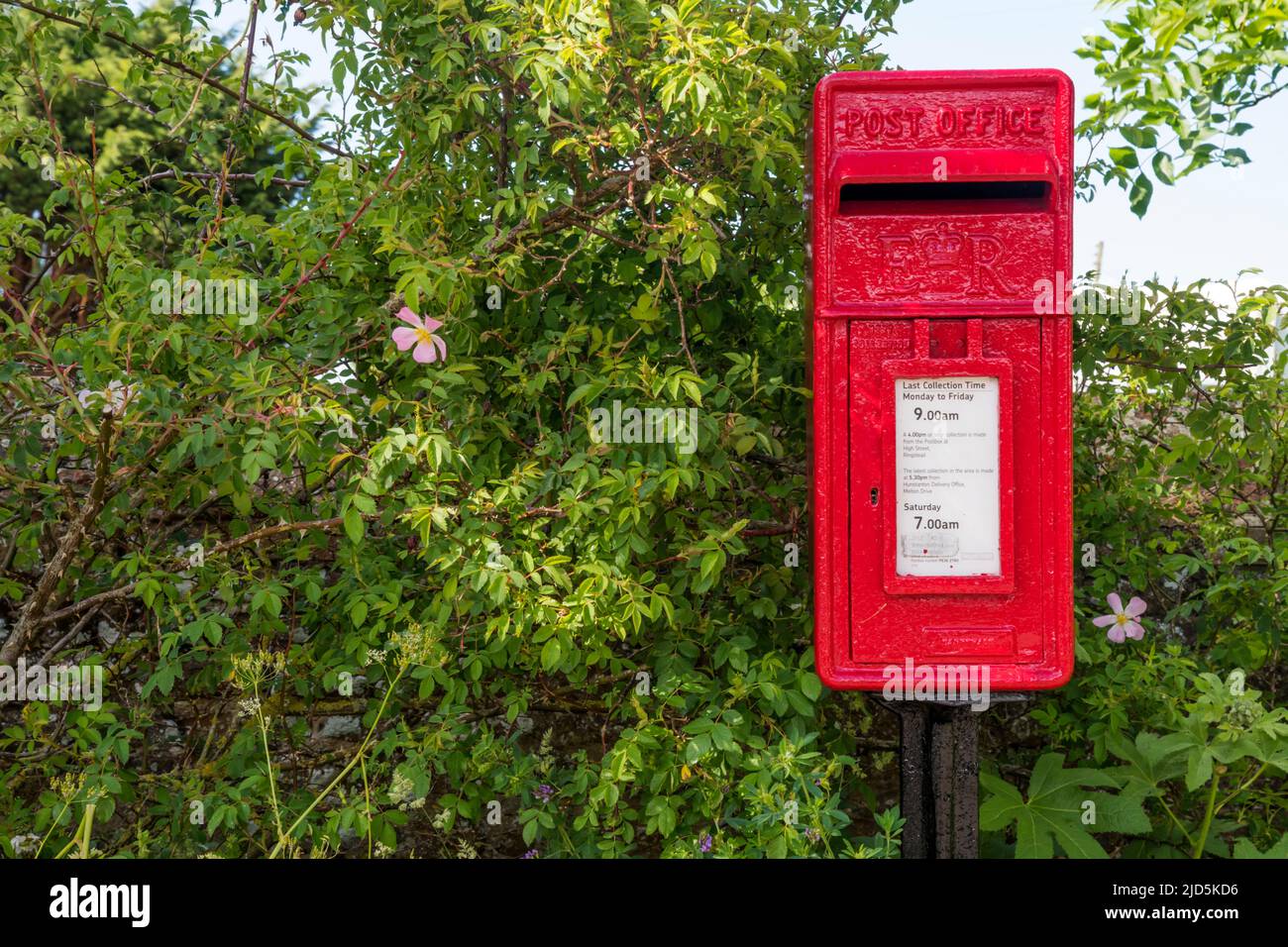 Red ER pillar box in village of Ringstead, Norfolk. Stock Photo