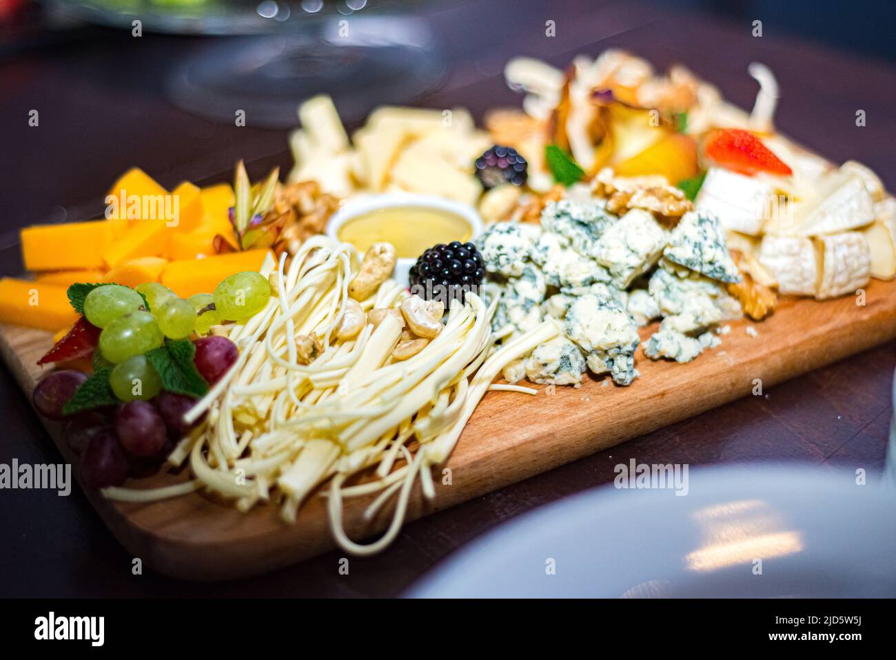 Cheese board with appetizers Cecil, blue mold cheese, cheddar, brie