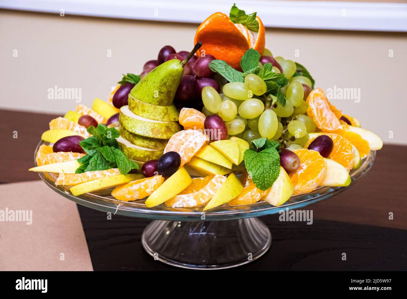 Fruit plate. Stylishly lined fruit orange slices, pear slices, grapes