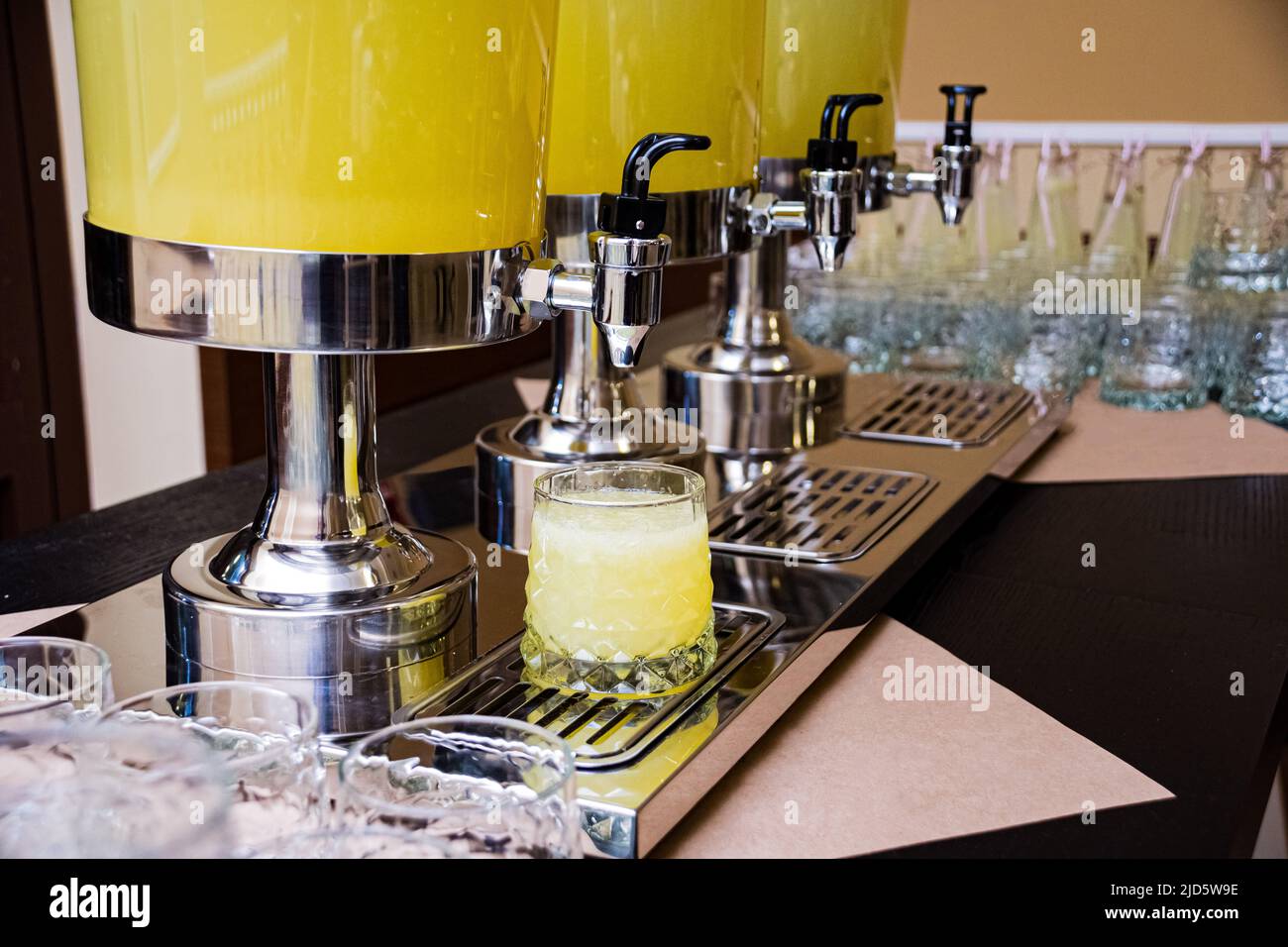 Three beverage dispensers with lemonade standing on the table