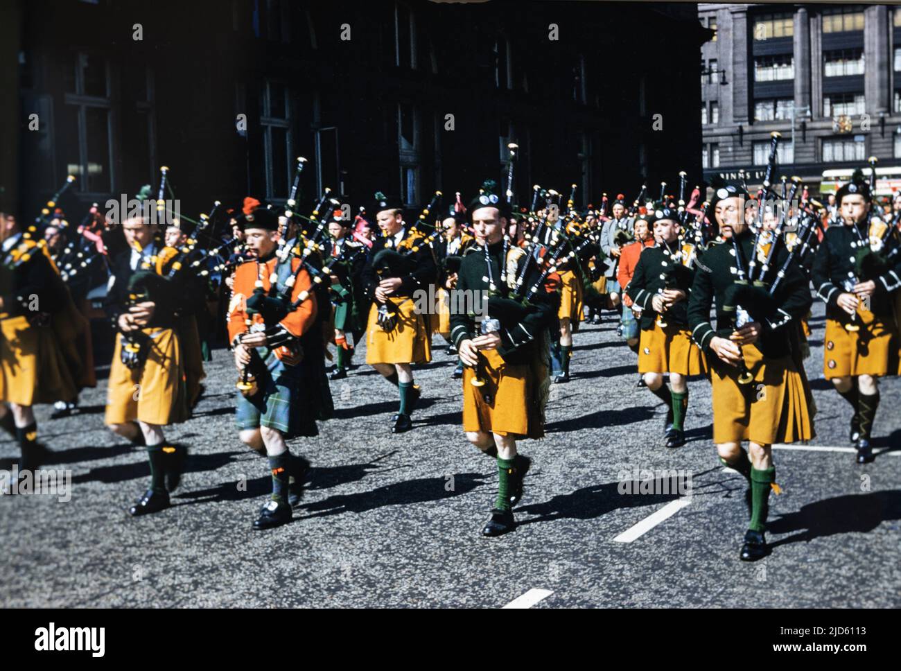 Historical photo of a an Irish marching pipe band playing bagpipes in