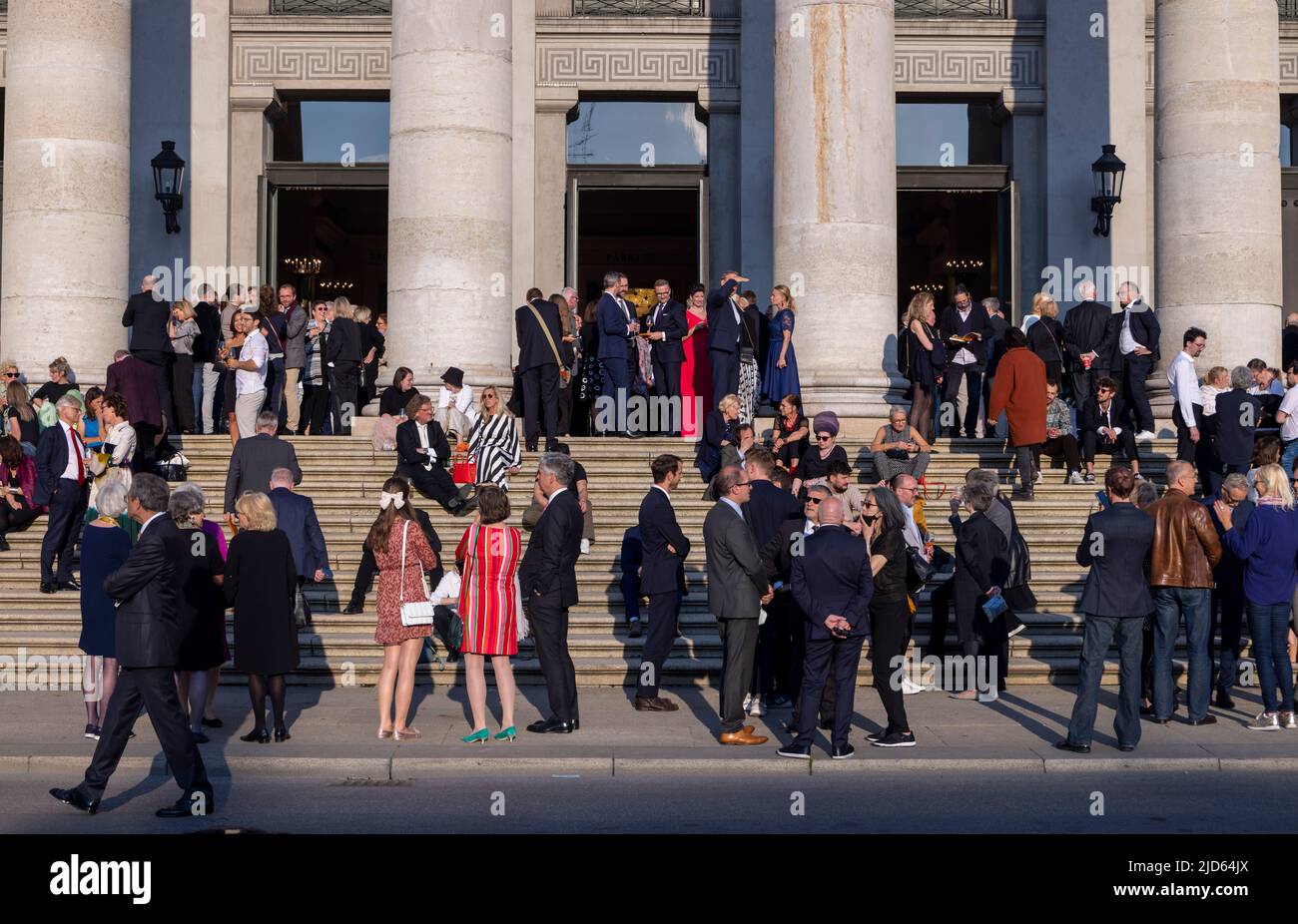patrons at intermission on the steps of the National Theatre (Nationaltheater), Munich, Bavaria, Germany Stock Photo