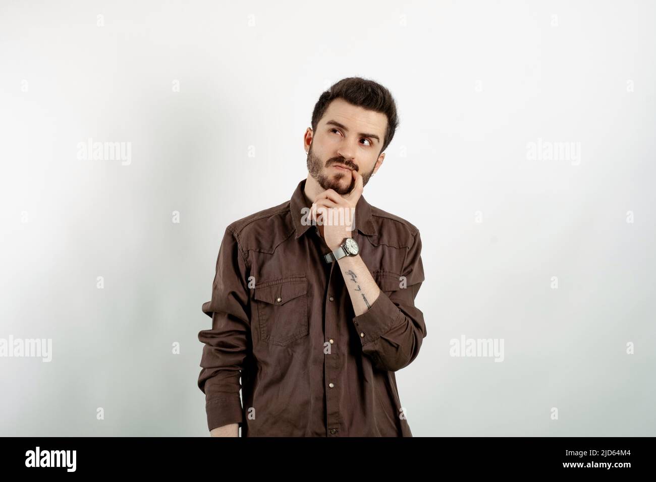 Caucasian man wearing brown shirt posing isolated over white background