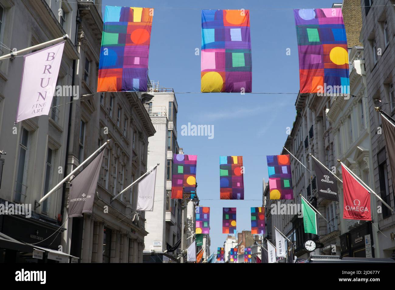 London, UK, 17 June 2021: To coincide with the Royal Academy's annual Summer Exhibition, flags with 11 different designs by Welsh artist Mali Morris RA are suspended above Old Bond Street. Anna Watson/Alamy Live News Stock Photo