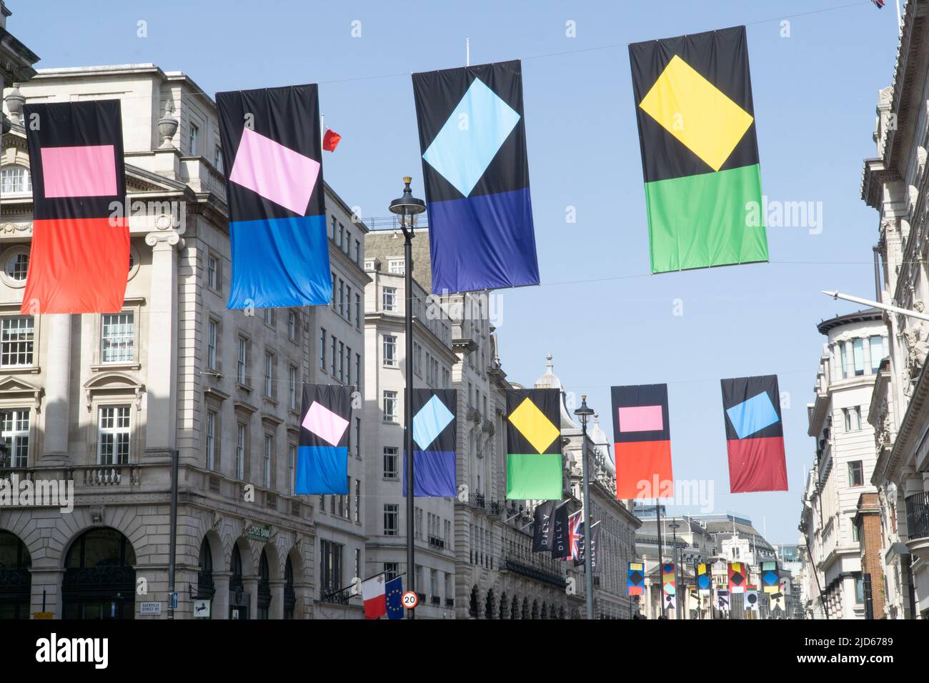 London, UK, 17 June 2021: To coincide with the Royal Academy's annual Summer Exhibition, flags with designs by artist Paul Huxley RA are suspended above Piccadilly in Mayfair. Anna Watson/Alamy Live News Stock Photo