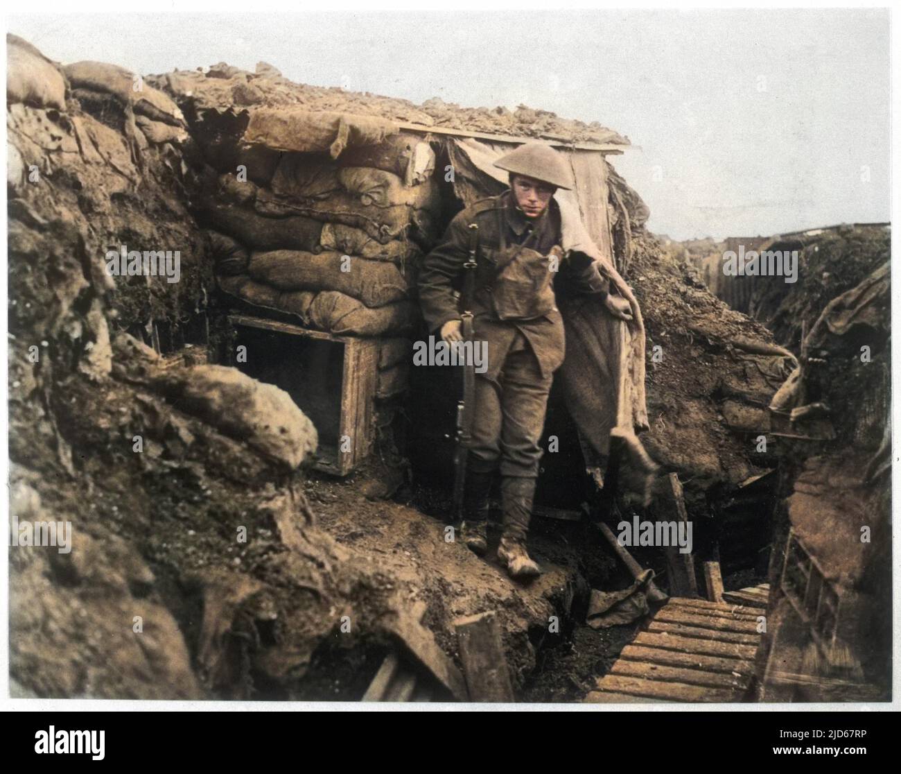 A young British soldier emerges from shelter in a trench. Colourised version of : 10023924 Stock Photo