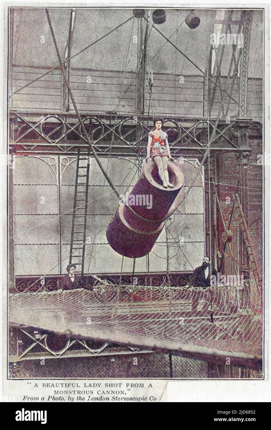 Zazel at the Royal Aquarium, London. 'A beautiful Lady shot from a monstrous cannon.' After a theatrical pause, the 'fuse' is lit, and Zazel shoots forth 35 feet from the spring loaded wooden cannon, landing in the ample safety net below. This is thought to be the earliest photograph of a human cannonball act. Colourised version of : 10062172       Date: 1877 Stock Photo