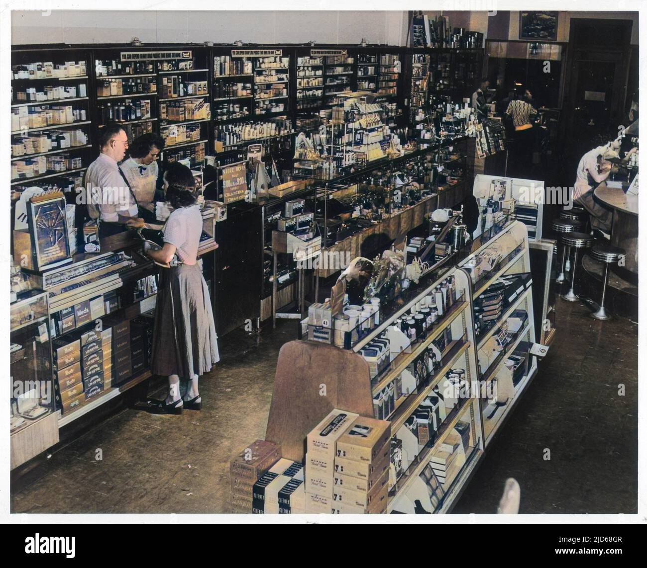 The well-stocked interior of a drugstore in an East Coast town in America complete with soda bar Colourised version of : 10101894       Date: circa 1950 Stock Photo