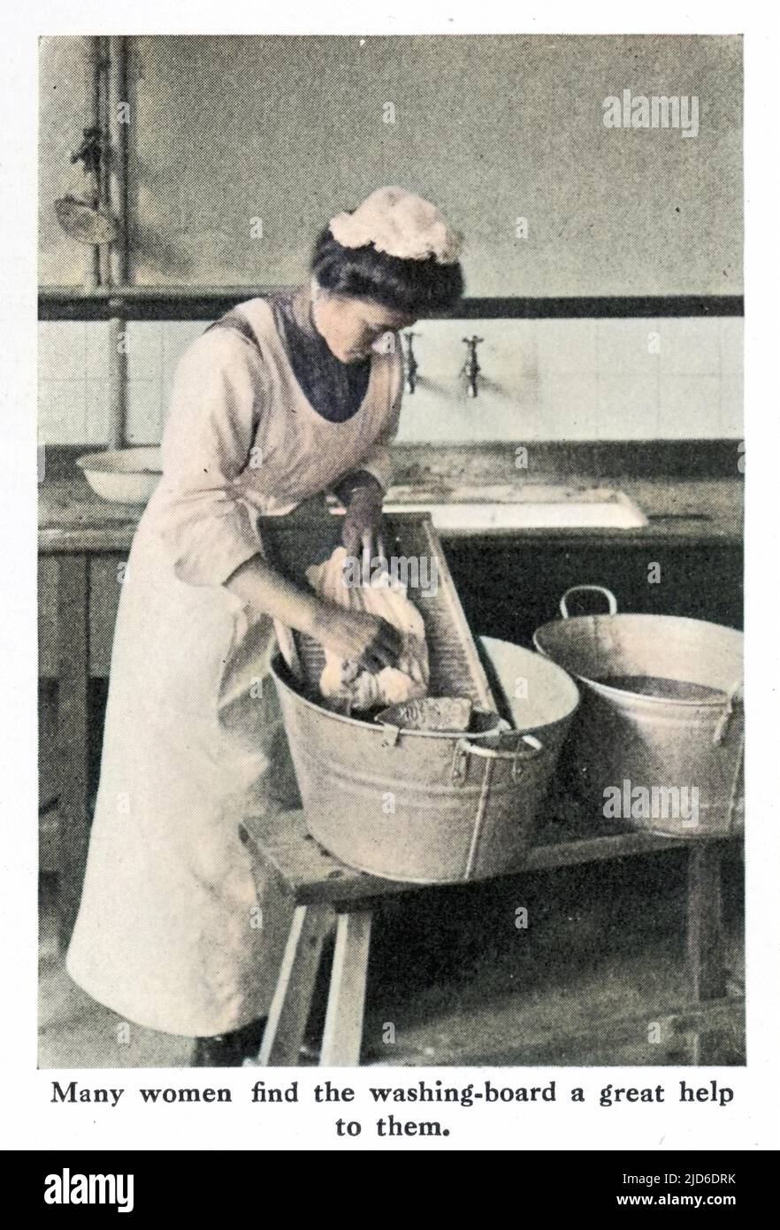 A photograph demonstrating the use of a scrubbing board in a tub during washday in the early 20th century. Colourised version of : 10195920       Date: 1911 Stock Photo