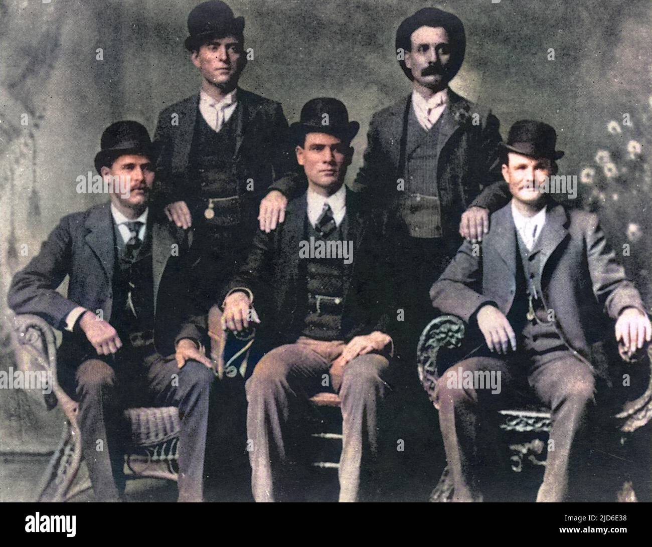 Members of The Wild Bunch in Fort Worth, Texas: sitting (l to r): Harry A Longabaugh, alias the Sundance Kid, Ben Kilpatrick, alias the Tall Texan, Robert Leroy Parker, alias Butch Cassidy; Standing (l to r): Will Carver, alias News Carver and Harvey Logan, alias Kid Curry. Colourised version of : 10513812       Date: 1900 Stock Photo