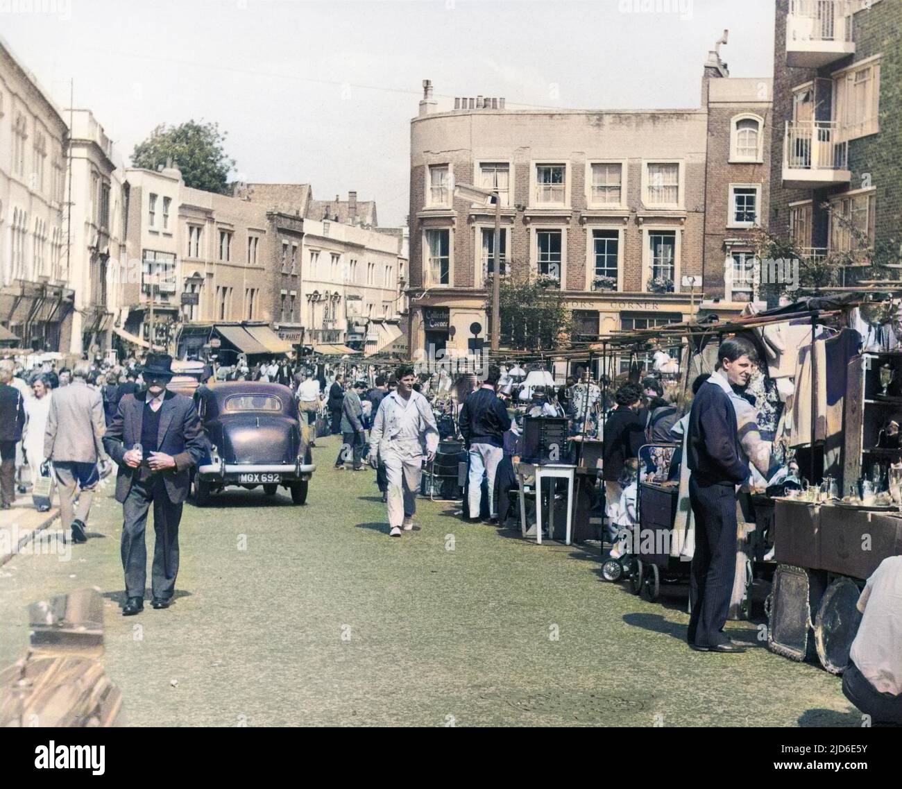 Browsing the stalls at Portobello Road market. Colourised version of : 10083323       Date: 1960s Stock Photo