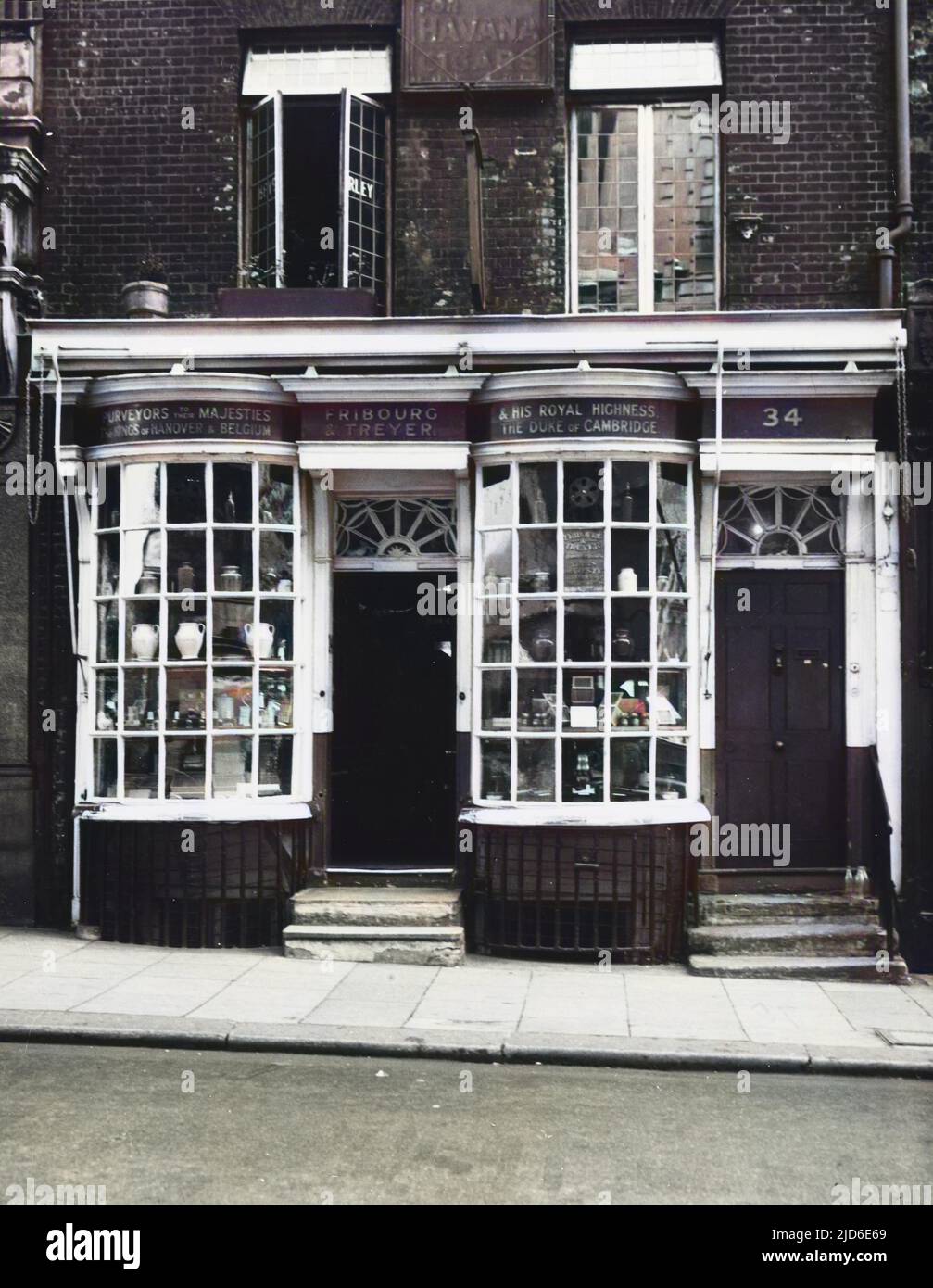 The famous (and charming) 18th century tobacco, cigar and snuff shop Treyer and Fribourg at 34 Haymarket, London, SW1. The shop enjoyed the patronage of George III, Pitt and many other famous statesmen. The owners sold the business to Imperial Tobacco who after a time said they could not afford the rent and moved premises to Regent Street. This shop also closed, but the name lived on for a while as Imperial Tobacco continued to market Treyer and Fribourg cigarettes. Snuff bearing the Treyer and Fribourg name is still available for purchase over the internet. Colourised version of : 10105025 Stock Photo