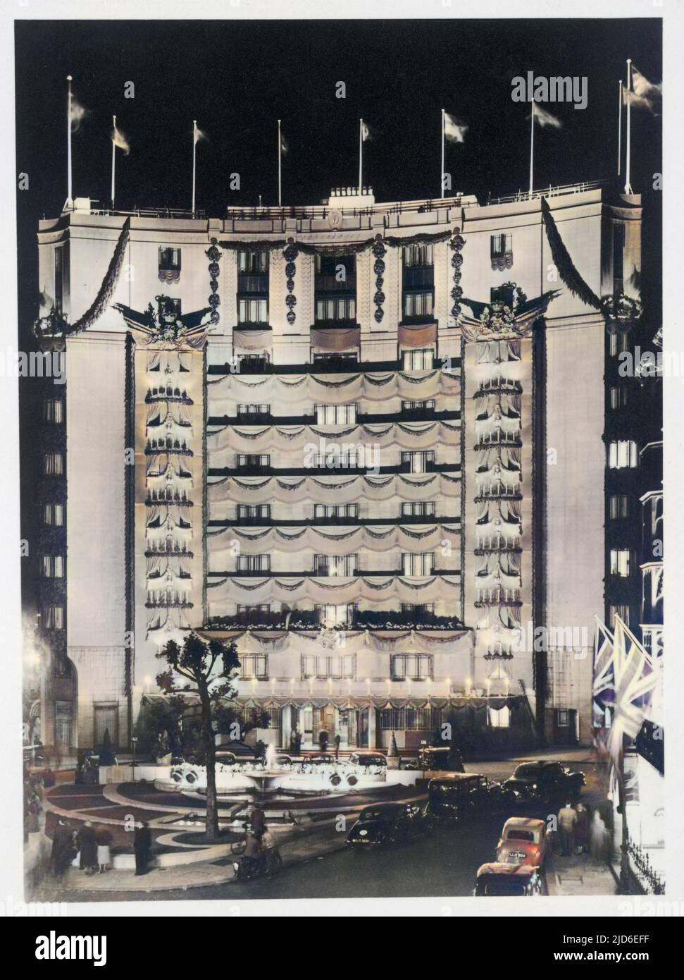 The Dorchester, 1953 - The front facade of the hotel decorated by theatre designer Oliver Messel for the Coronation of Queen Elizabeth II. Colourised version of : 10145620       Date: 1953 Stock Photo