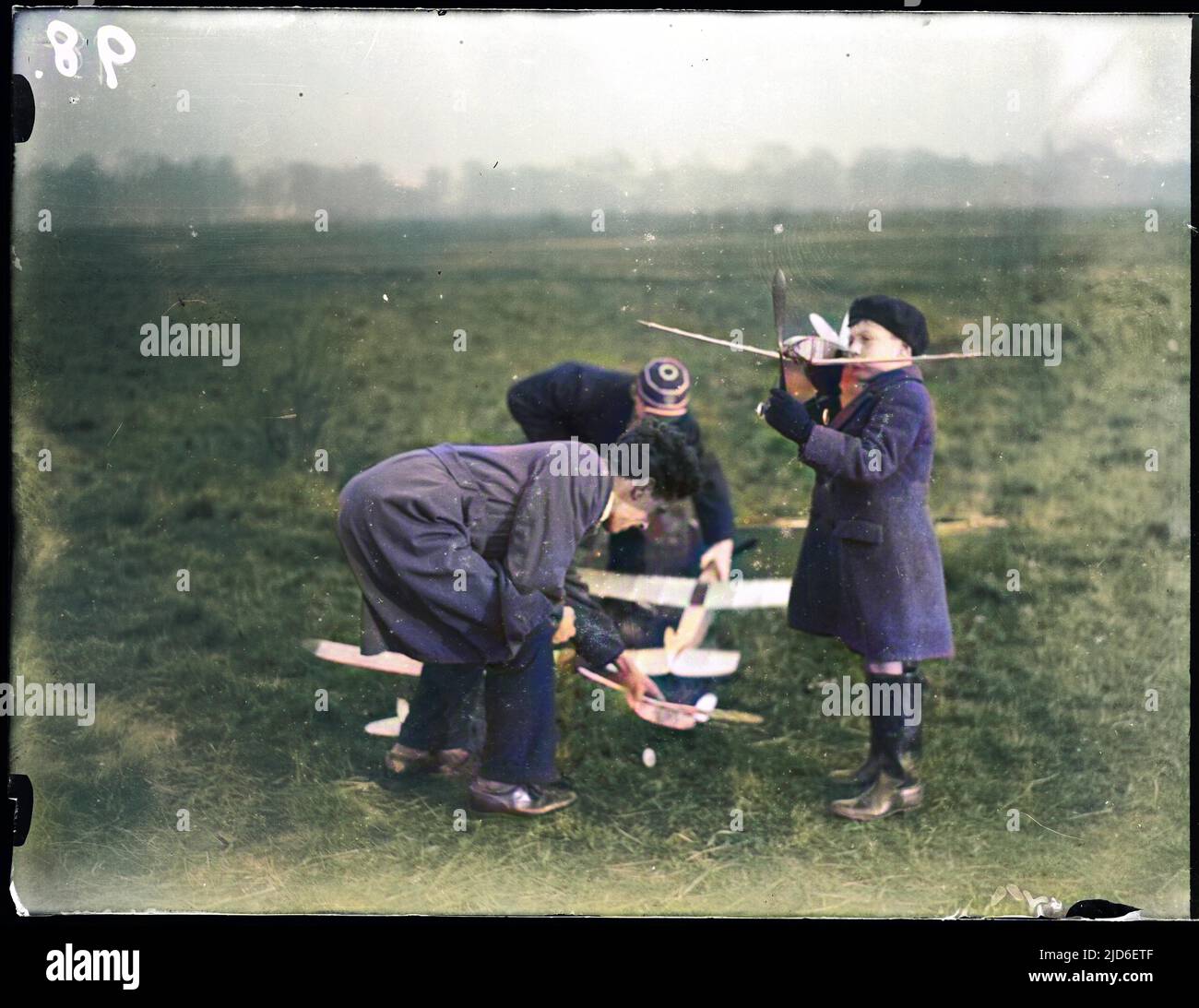 Playing with model aeroplanes on Wimbledon Common, London, England. Colourised version of : 10161761       Date: early 1930s Stock Photo