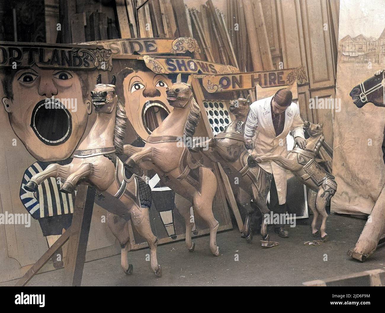 Retouching the paintwork of the wooden carousel horses of 'Portland's ...