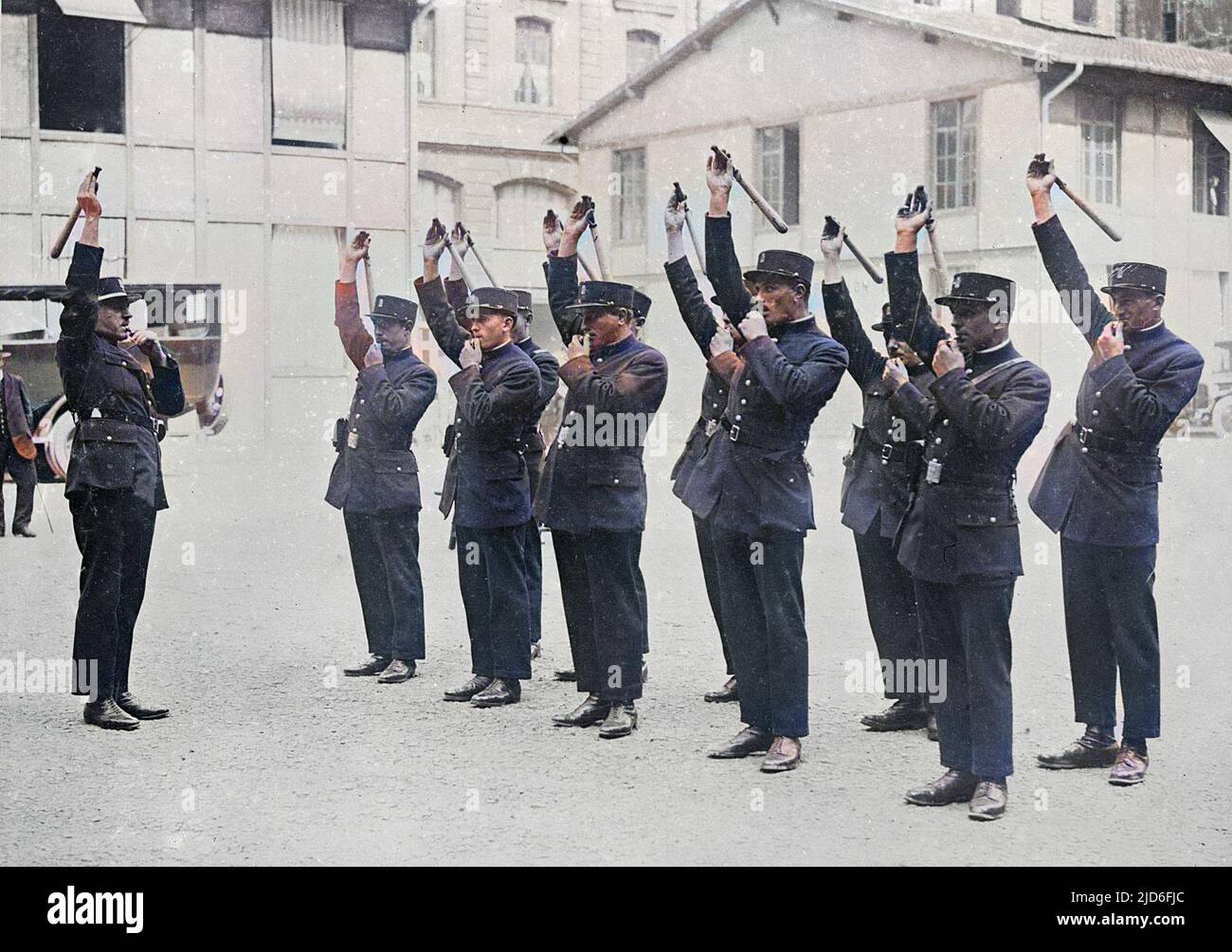 French police cadets saluting and blowing whistles during a training session. Colourised version of : 10165072       Date: early 1930s Stock Photo