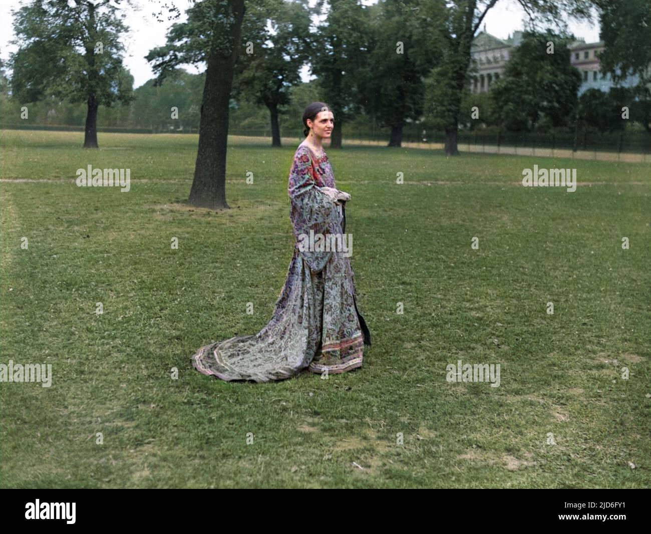A young woman models a 'medieval' style dress, Regent's Park, London. Colourised version of : 10168958       Date: early 1930s Stock Photo