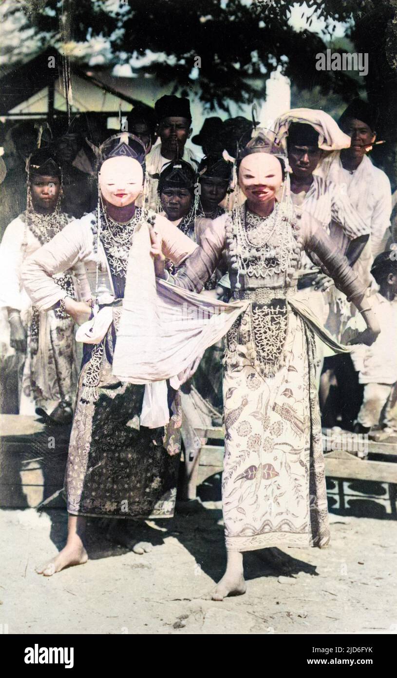 Native dancing girls in traditional masks and elaborate dress, Java ...