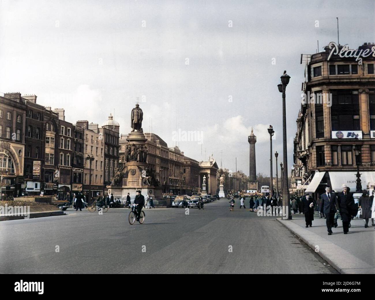 O'Connell Street, Dublin, Ireland, looking north from the River Liffey. In the centre is the bronze O'Connell Monument, the G.P.O, Building and Nelson Monument behind. Colourised version of : 10171773       Date: 1960s Stock Photo
